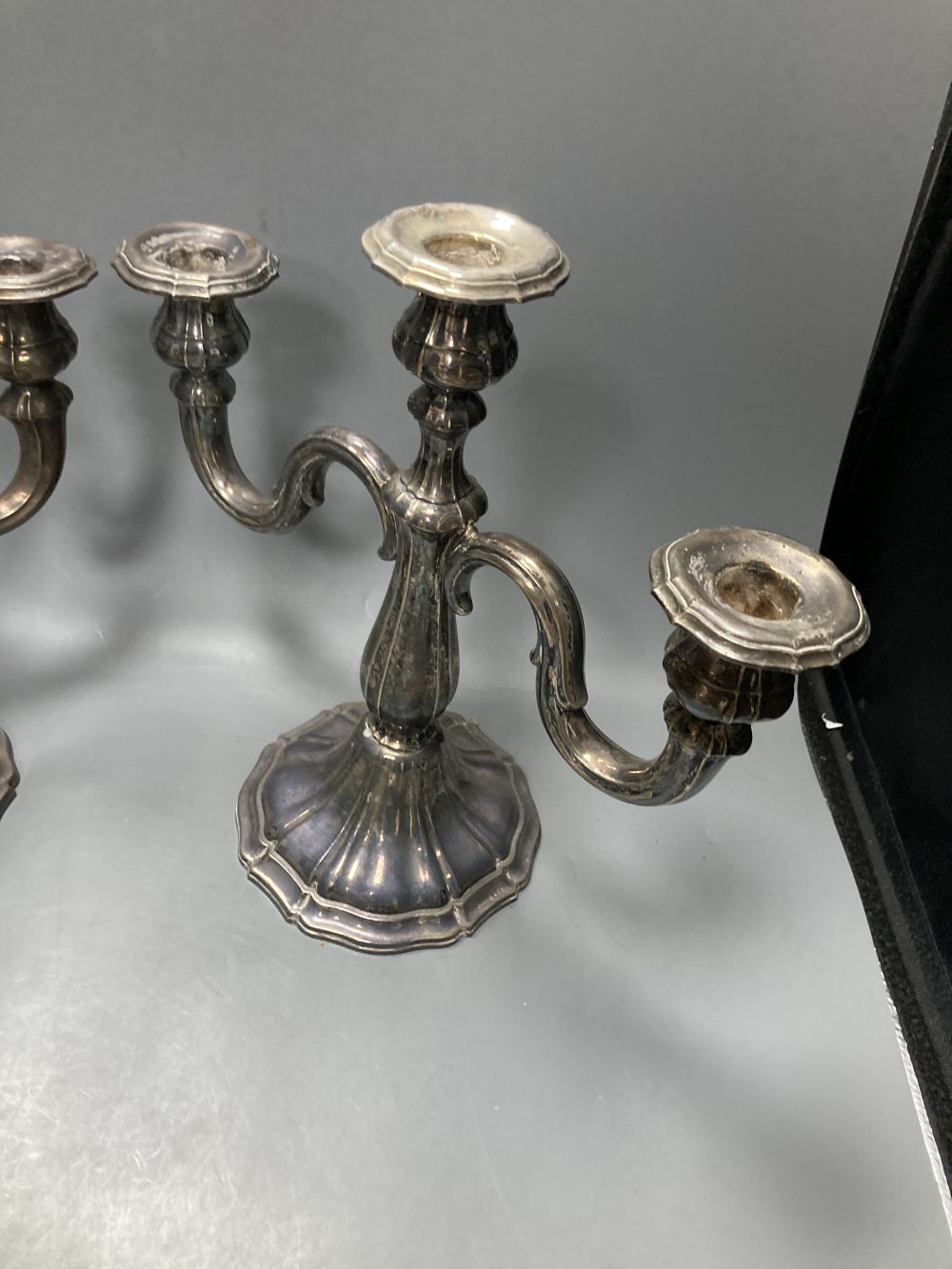 An early 20th century German 925 standard candelabrum and pr of candelabra